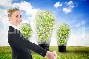 Composite image of businesswoman holding piggy bank