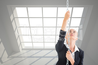 Composite image of businesswoman pulling a chain