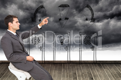 Composite image of businessman sitting and pointing the finger