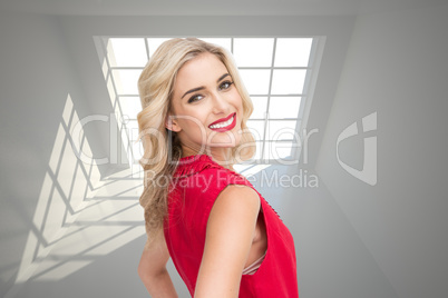 Composite image of smiling blonde standing hands on hips