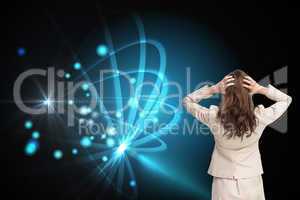 Composite image of businesswoman with hands on head standing bac