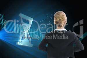 Composite image of businesswoman standing with hands on hips