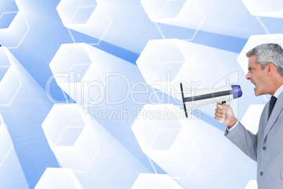 Composite image of businessman shouting in loudspeaker