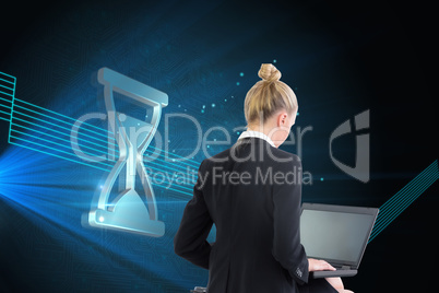 Composite image of businesswoman using laptop