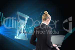 Composite image of businesswoman using laptop