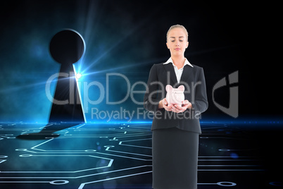 Composite image of businesswoman holding pink piggy bank