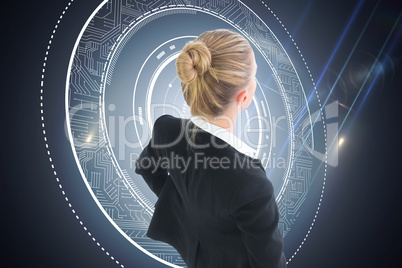 Composite image of businesswoman standing with hands on hips