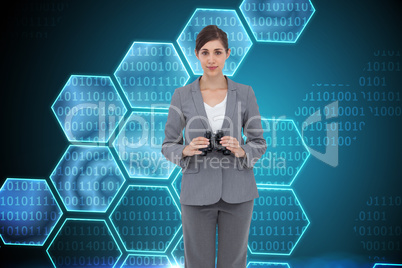 Composite image of young businesswoman with binoculars