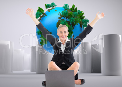 Composite image of businesswoman sitting in front of laptop with