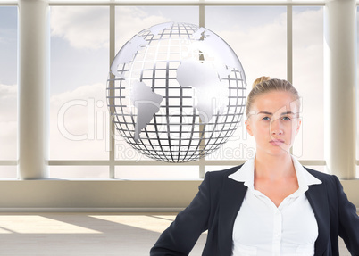 Composite image of businesswoman standing with hands on hips