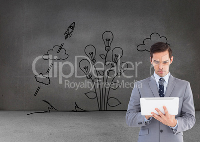 Composite image of businessman holding a tablet computer