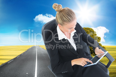 Composite image of businesswoman sitting on swivel chair with ta