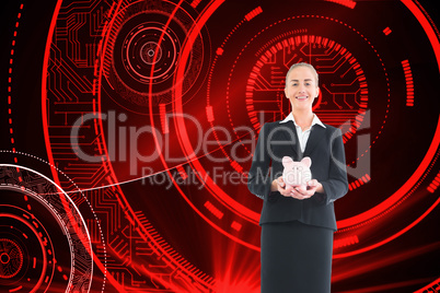 Composite image of businesswoman holding pink piggy bank