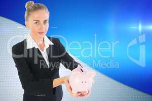 Composite image of businesswoman holding piggy bank