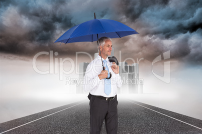 Composite image of happy businessman holding umbrella