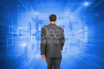 Composite image of young businessman walking away from camera