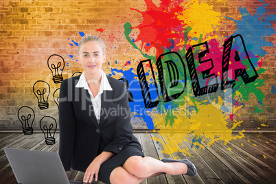 Composite image of businesswoman using laptop Composite image of businesswoman using laptop