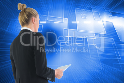 Composite image of businesswoman holding tablet