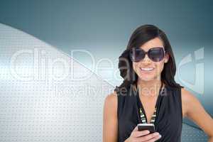 Composite image of happy brunette holding smartphone