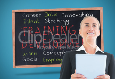 Composite image of businesswoman holding tablet