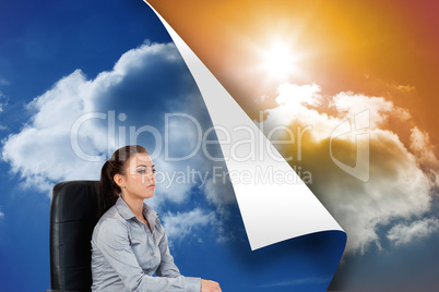 Composite image of portrait of a serious businesswoman sitting o