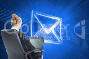 Composite image of businesswoman sitting on swivel chair with la