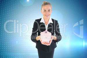 Composite image of businesswoman holding pink piggy bank