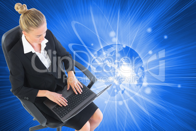 Composite image of businesswoman sitting on swivel chair with la