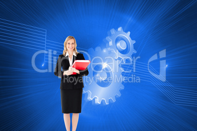 Composite image of businesswoman smiling and holding folders