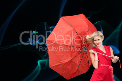 Composite image of smiling blonde holding umbrella