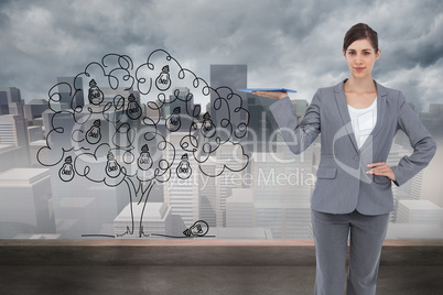 Composite image of smiling businesswoman holding tablet pc