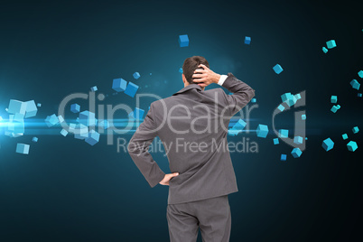 Composite image of young businessman standing back to camera scr