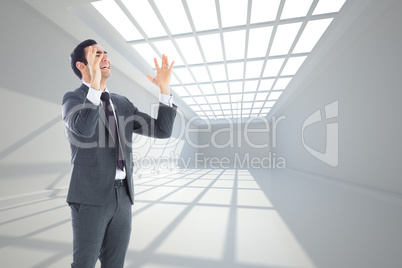 Composite image of stressed businessman with arms raised