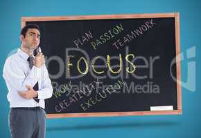 Composite image of thinking businessman holding glasses