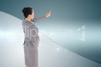 Composite image of asian businesswoman pointing