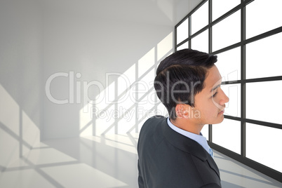 Composite image of serious asian businessman