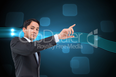 Composite image of serious asian businessman pointing