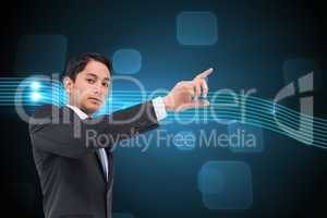 Composite image of serious asian businessman pointing