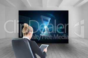 Composite image of businesswoman sitting on swivel chair with ta