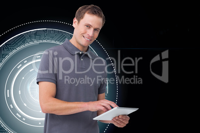 Composite image of smiling young man with tablet computer