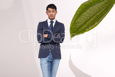 Composite image of unsmiling casual businessman with arms crosse