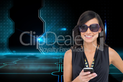 Composite image of happy brunette holding smartphone