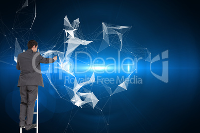 Composite image of businessman standing on ladder