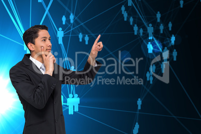 Composite image of thoughtful asian businessman pointing