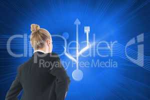 Composite image of businesswoman standing with hands on hips