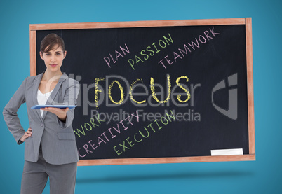 Composite image of attractive businesswoman holding tablet pc