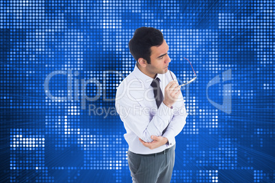 Composite image of unsmiling businessman holding glasses