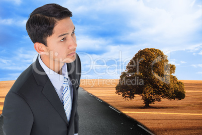 Composite image of serious asian businessman