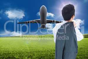 Composite image of businessman standing