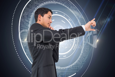 Composite image of thoughtful asian businessman pointing